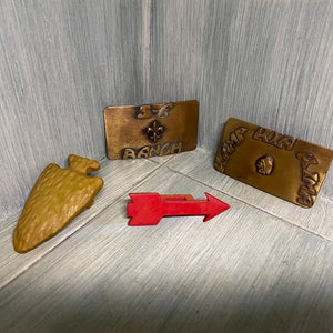 Boy Scout belt buckles & neckerchief slides.