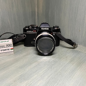 Konica Autoreflex TC 35mm camera with 50mm lens. I also comes with Forte (gray box) of expired film.