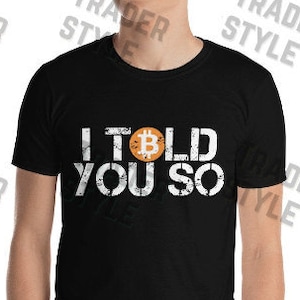May include: Black t-shirt with a white graphic that says "I told you so" with a Bitcoin symbol in the middle of the word "told".