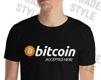May include: Black t-shirt with a white graphic of a bitcoin logo and the text "bitcoin accepted here".