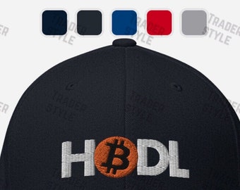 May include: A navy blue baseball cap with a white embroidered Bitcoin logo and the word "HODL" in white.
