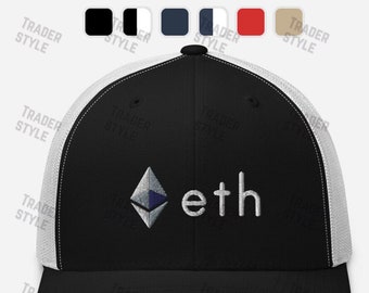 May include: Black and white trucker hat with a white mesh back. The hat has a blue and white Ethereum logo and the word "eth" embroidered on the front.