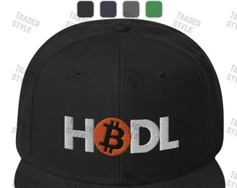 May include: Black and white embroidered baseball cap with an orange Bitcoin logo and the word "HODL" in white.