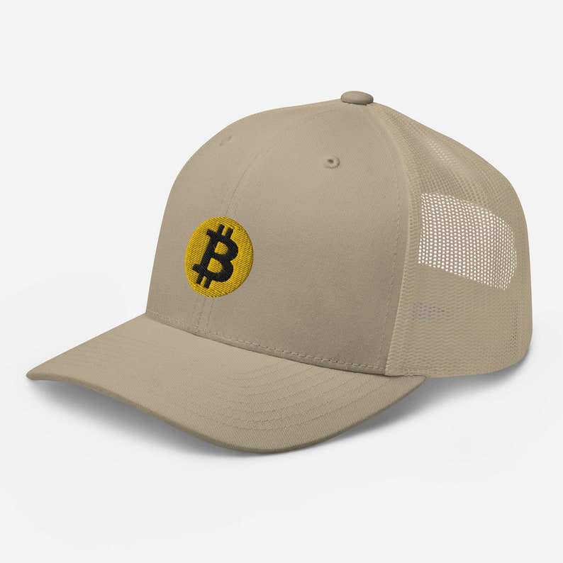 May include: A beige and black baseball cap with a yellow embroidered Bitcoin logo. The cap has a mesh back.