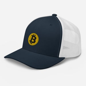 May include: A navy blue and white trucker hat with a yellow embroidered Bitcoin symbol.