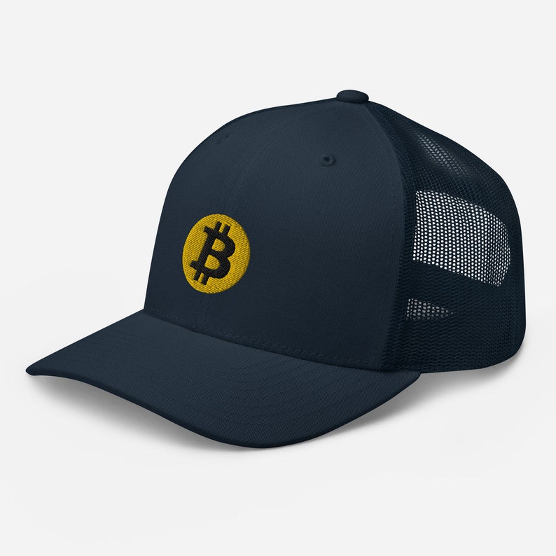 May include: A navy blue trucker hat with a yellow embroidered Bitcoin symbol.