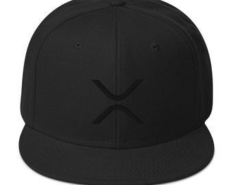 May include: A black and white embroidered logo of a stylized 'X' on a black fitted baseball cap.