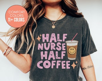 May include: A gray t-shirt with a pink graphic that says "Half Nurse Half Coffee" with a cartoon coffee cup and a pink straw.