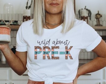 May include: White t-shirt with the text "wild about PRE-K" in pink, blue, and black leopard print.