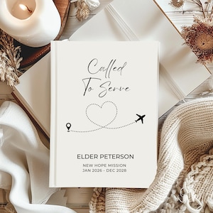 May include: A cream-coloured journal with the words "Called To Serve" in elegant script. A dotted line forms a heart shape with a small aeroplane icon. The journal is personalised with a name, mission, and dates.