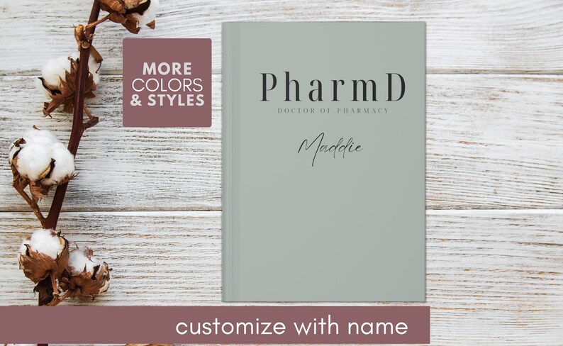 May include: A light green journal with the text "PharmD Doctor of Pharmacy" and the name "Maddie" written in cursive. The journal is on a white wooden background.