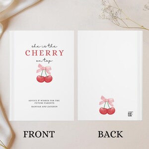 May include: A white card with the text "she is the CHERRY on top" in red and black. There is a drawing of two red cherries with a pink ribbon on top. The text "ADVICE & WISHES FOR THE FUTURE PARENTS HANNAH AND JACKSON" is below the cherries. The card says "FRONT" at the bottom.