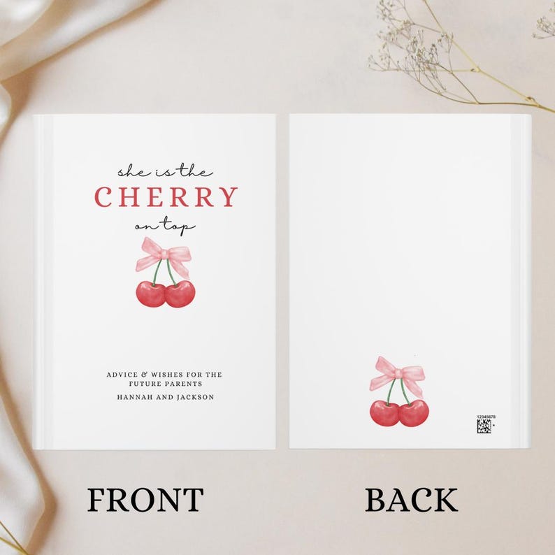 May include: A white card with the text "she is the CHERRY on top" in red and black. There is a drawing of two red cherries with a pink ribbon on top. The text "ADVICE & WISHES FOR THE FUTURE PARENTS HANNAH AND JACKSON" is below the cherries. The card says "FRONT" at the bottom.