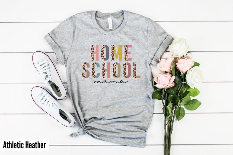 May include: Gray t-shirt with the text "HOME SCHOOL mama" in colorful letters with a leopard print pattern.