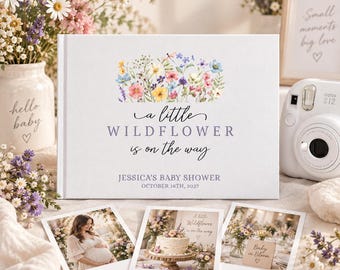 Peut inclure: Un album photo rectangulaire blanc orné d'une illustration aquarelle de fleurs sauvages et du texte A little WILDFLOWER is on the way, JESSICA'S BABY SHOWER, OCTOBER 16TH, 2027. Trois photos de style polaroïd sont disposées devant l'album.