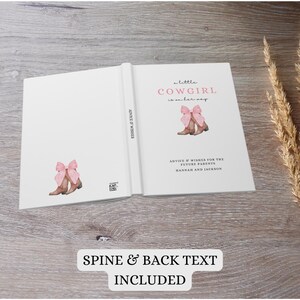 Puede incluir: Un libro blanco con una ilustraci&oacute;n rosa y marr&oacute;n de botas de vaquero con un lazo rosa. El texto de la portada dice "a little cowgirl is on her way". El lomo del libro dice "Advice & Wishes". La contraportada dice "Advice & Wishes for the Future Parents Hannah and Jackson".