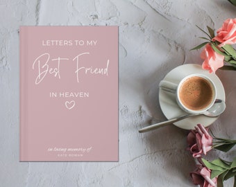 May include: A pink journal with the text "Letters to my Best Friend in Heaven" in white lettering. The journal has a small heart symbol and the text "in loving memory of Kate Rowan" in smaller white lettering.