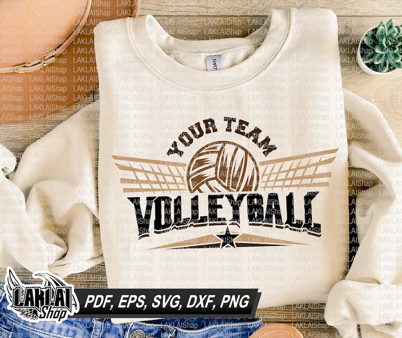 May include: A white sweatshirt with a brown and black volleyball graphic. The graphic includes the text "Your Team Volleyball" with a brown volleyball and a brown net with wings.