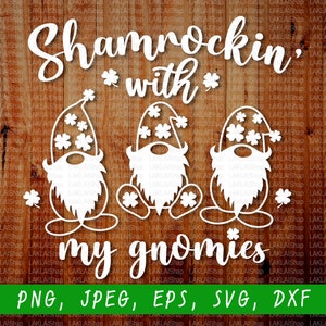 May include: White silhouette of three gnomes wearing hats with shamrocks on them. The gnomes are sitting with their legs crossed. The text "Shamrockin' with my gnomies" is above the gnomes. The text "PNG, JPEG, EPS, SVG, DXF" is below the gnomes.