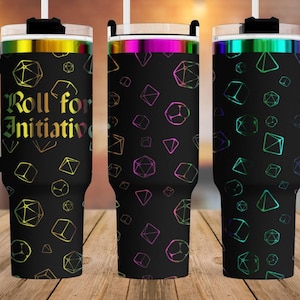 May include: Three stainless steel tumblers with black lids and handles. The tumblers are decorated with a black background and a pattern of colorful dice. The tumbler on the left has the text "Roll for Initiative" on the front.