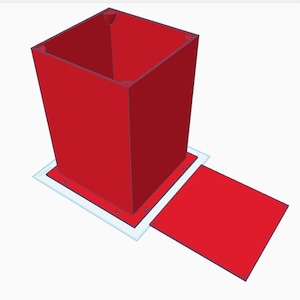 May include: A red, rectangular box with a matching lid. The box is open at the top and sits on a white base. The lid is positioned to the side, suggesting it can be opened and closed. The design is simple and geometric.