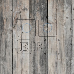 May include: Black and white wooden sign with the letters "EE" and two circles. The sign is made of wood and has a rustic look.