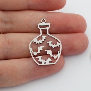 May include: Two silver metal charms shaped like potion bottles with a bat pattern.