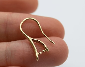 May include: Gold-toned earring hook with a loop at the top and a small opening at the bottom for attaching an earring.