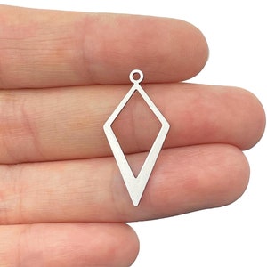 May include: A silver-toned metal charm in the shape of an elongated diamond or rhombus. The charm features a hollow center and a small circular loop at the top for attachment. The piece has a smooth, flat surface with a clean, geometric outline.