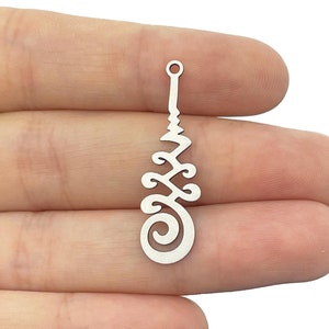 May include: Silver charm with a detailed, intricate design resembling a stylized tree or plant. The charm has a loop at the top for attaching to jewelry.