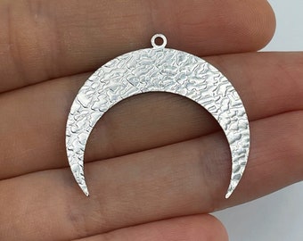 May include: Silver crescent moon pendant with a hammered texture. The pendant has a loop at the top for attaching to a chain or cord.
