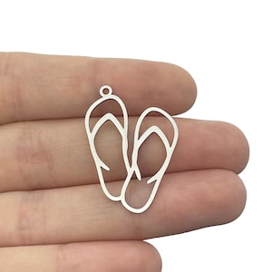 May include: Silver charm in the shape of two flip flops. The charm is designed to be used for jewelry making.