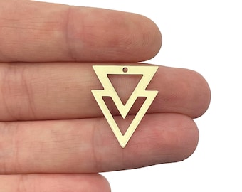 May include: A gold-toned metal pendant featuring a geometric design composed of two nested, open-frame triangles pointing downward. The piece has a small circular hole at the top center for attachment, showcasing a clean, flat, and symmetrical shape.