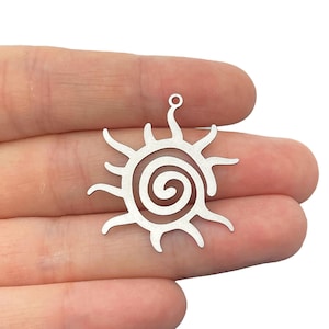 May include: Silver charm featuring a sun design with a spiral in the centre. The charm has a hole at the top for attaching to a necklace or bracelet.
