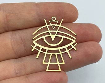 May include: Gold metal charm with a geometric eye design. The eye is outlined in a circle with radiating lines. The charm has a loop at the top for attaching to jewelry.