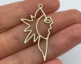 May include: A gold-toned metal pendant featuring a continuous line art design that combines a sunburst shape on the left with a stylized human face profile on the right. The piece includes a small circular loop at the top for attachment.