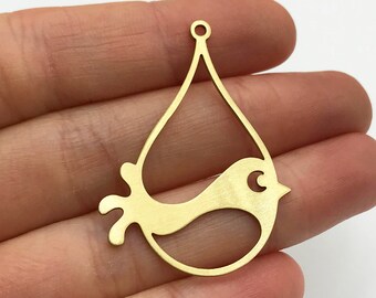 May include: A gold-toned metal pendant shaped like a stylized bird silhouette integrated into a teardrop frame. The flat, cutout design features a small circular loop at the top for attachment, with smooth, clean edges and a matte metallic finish.