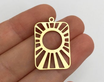 May include: A gold-toned rectangular metal pendant featuring a central circular cutout surrounded by radiating sunburst lines. The flat, die-cut charm includes a small circular loop at the top center for attachment, showcasing a clean, geometric design.