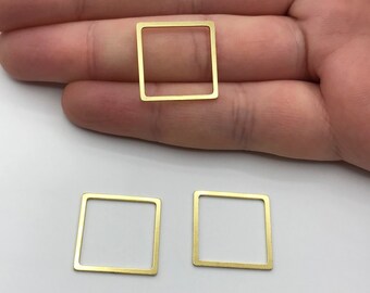 May include: Three gold-colored metal square frames. The frames are hollow and have a smooth finish.