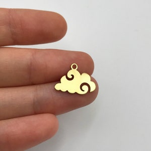 May include: Gold-colored metal charm shaped like a cloud with swirling details. The charm has a small loop at the top for attaching to jewelry or other crafts.