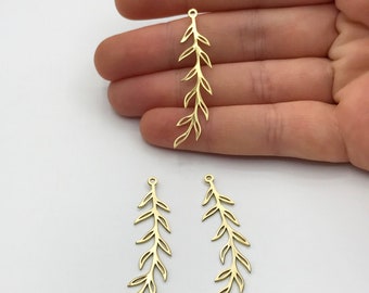 May include: Three gold-colored metal charms shaped like slender, elongated leafy branches. Each charm features a delicate, open-work design with a small circular loop at the top for attachment, showcasing a symmetrical botanical vine pattern.