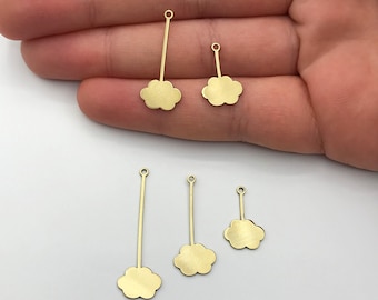May include: Five gold-colored metal charms shaped like clouds with a loop at the top. Each charm has a thin metal rod extending from the bottom of the cloud.