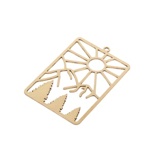 May include: Gold metal charm with a cutout design of a sun, mountains, and trees. The charm has a hole at the top for attaching to a necklace or bracelet.