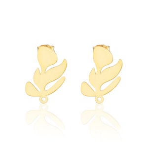 Puede incluir: Un par de pendientes de botón de hoja dorada. Los pendientes están hechos de metal y tienen un diseño simple y elegante.