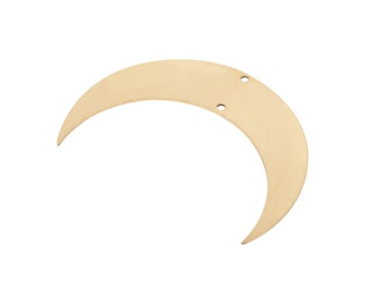 May include: A crescent moon-shaped pendant made of brushed gold-tone metal. The piece features a smooth, matte finish and includes two small circular holes positioned near the top edge for attachment purposes, presenting a simple, flat design.
