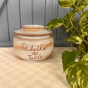 May include: A handmade wooden sign with the text "Welcome to our home" in a handwritten style. The sign is painted white with black lettering and a distressed finish, perfect for home decor.