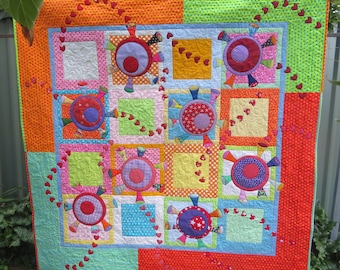 Whimsical, fun and colourful quilt PDF pattern 'Happiness Pandemic' spreading love and happiness through the world.