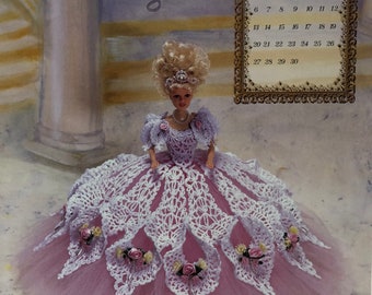 May include: A doll in a lavender and white crocheted gown with a pink tulle skirt. The doll has blonde hair and is wearing a pearl necklace and a tiara. The image includes a calendar for September 1998 and the text "An Annie Potter Original."