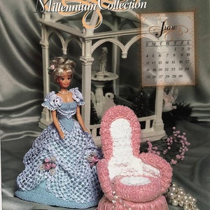 May include: A doll in a crocheted blue dress and a pink crocheted chair are featured on a book cover. The cover reads "2000 Millennium Collection" and "June" with a calendar. The doll has blonde hair and a pearl necklace.