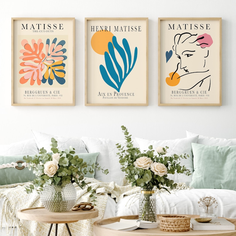 May include: Three framed art prints featuring abstract designs by Henri Matisse. The prints are in a minimalist style with a white background and colorful shapes. The text on the prints reads "Matisse", "The Cut-Outs", "Henri Matisse", "Aix en Provence", "Pavillon de Vendome", "Bergguen & Cie", "24 Rue de l'Universite Paris-VII", and "10, Rue de l'Universite Paris-VII".
